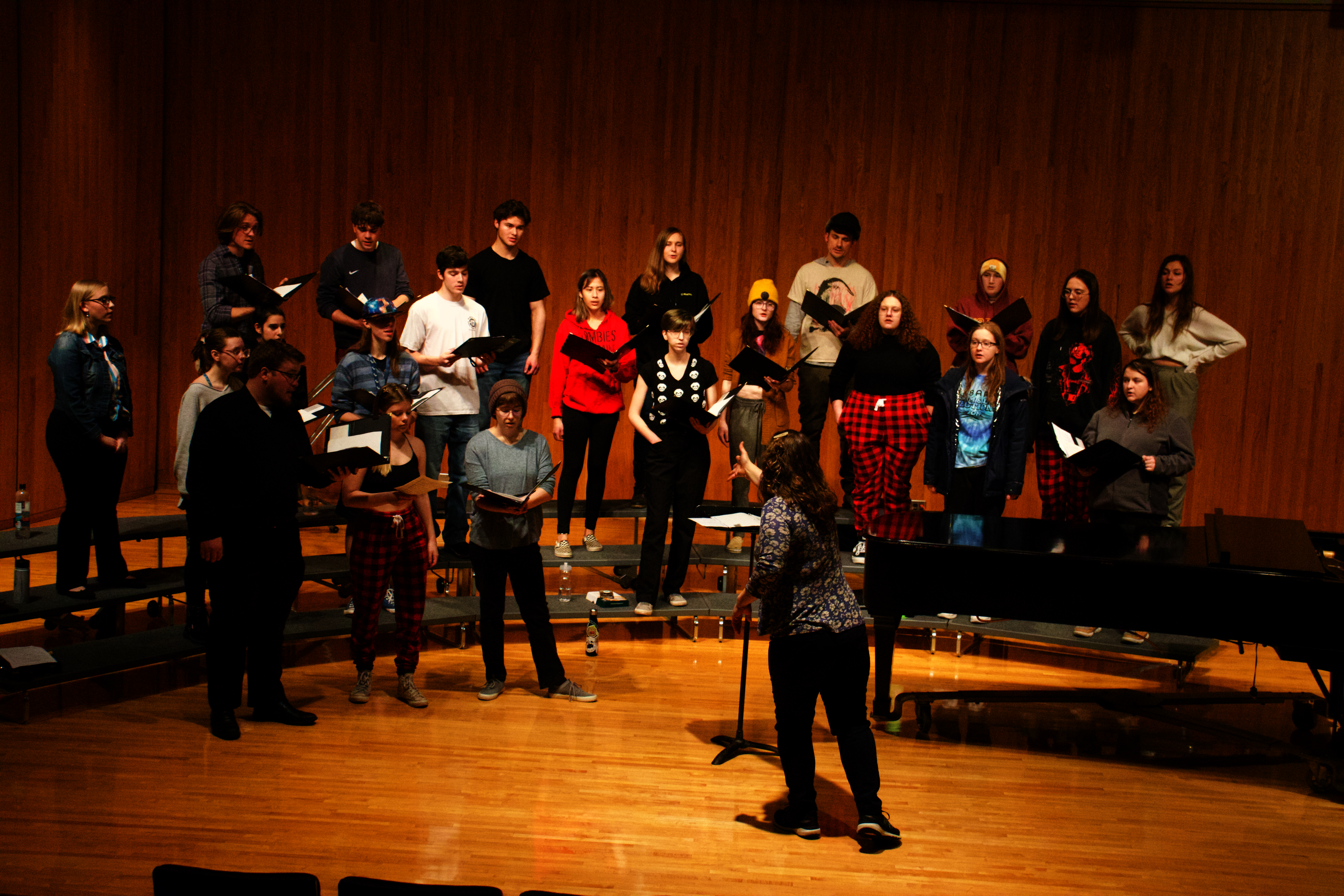 A mixed choir on risers singing