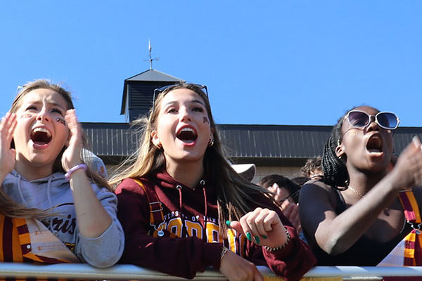 Students cheering at a UMN Morris Cougars football game