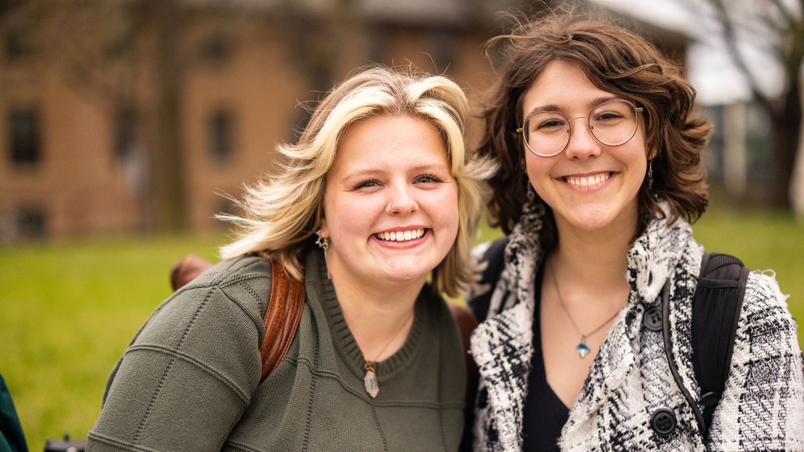 Two students smiling and posing for a photo