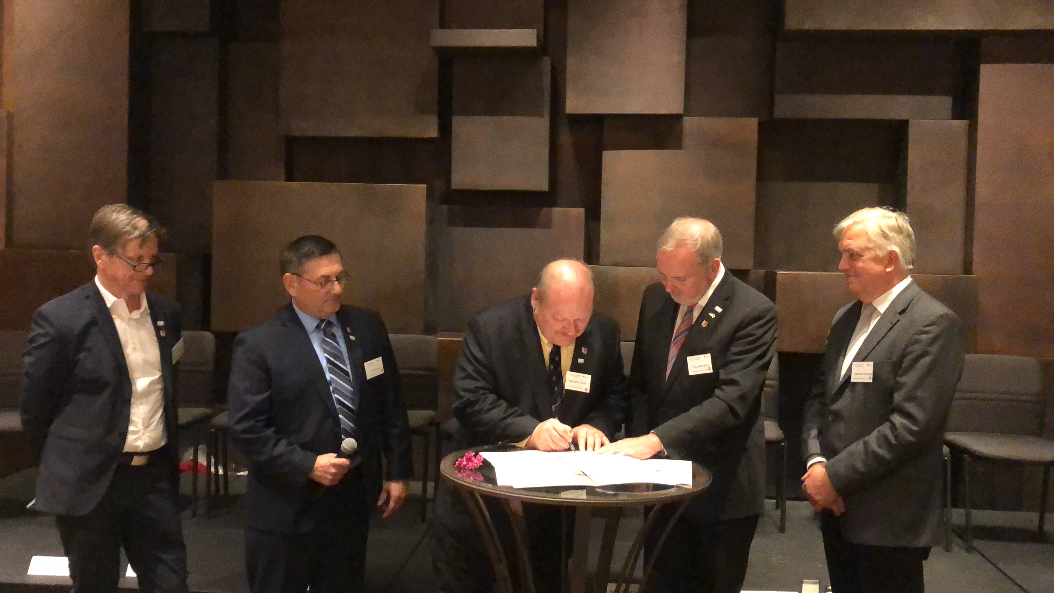 Photo of the signing of the second and perpetual Climate Protection Partner Agreement with representatives from the City of Morris and the City of Saerbeck, Germany.