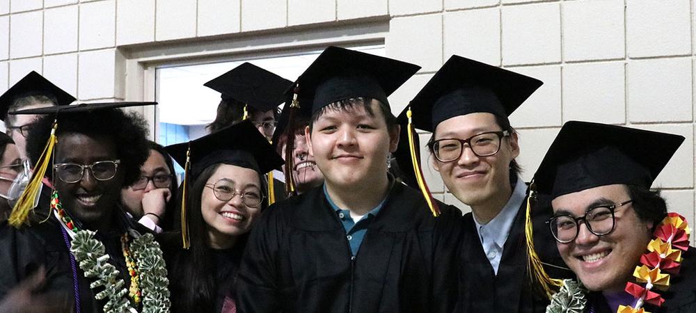 A group of graduates smiling on graduation day