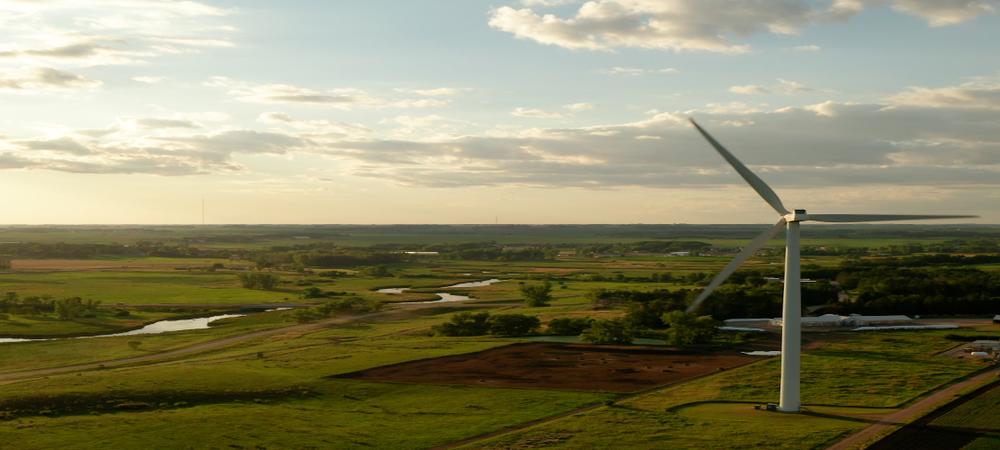 a drone photo of the Pomme de Terre River valley, with a wind turbine on the east bank