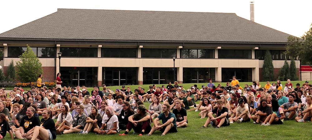 students sitting on campus mall