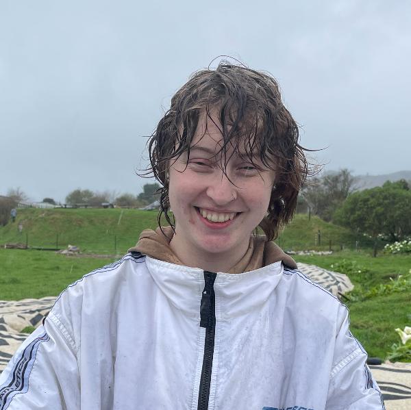 a photo of Abi Bartlett, a young person with short brown hair.  She is standing in the rain. 