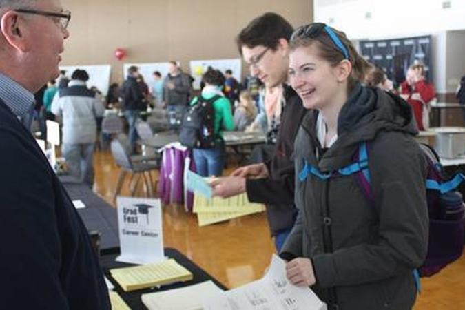 Career counselor talking with a student at a job fair