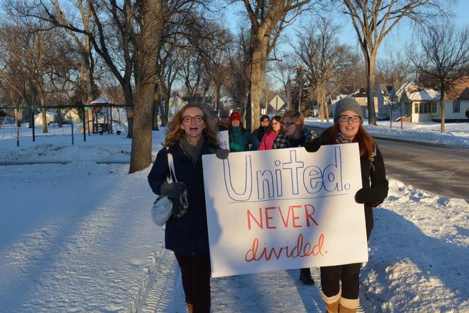 Students holding a sign that reads United Never Divided 
